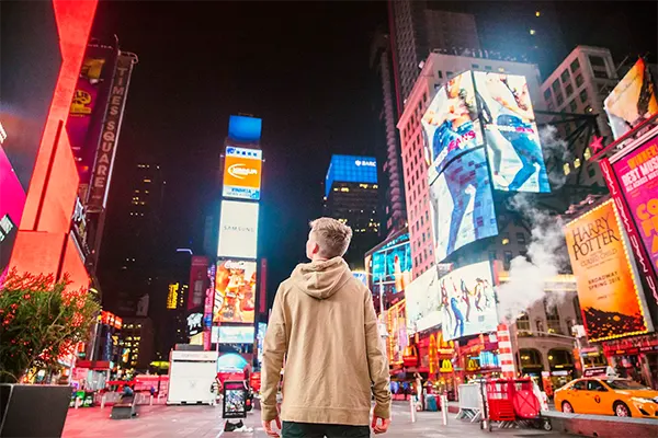 Man looking at ads on high-rise buildings